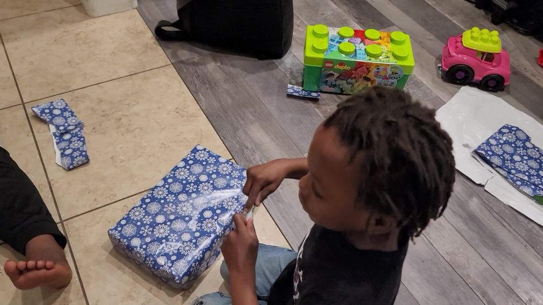 J Funk and Josiah wrap Christmas presents for their cousins
