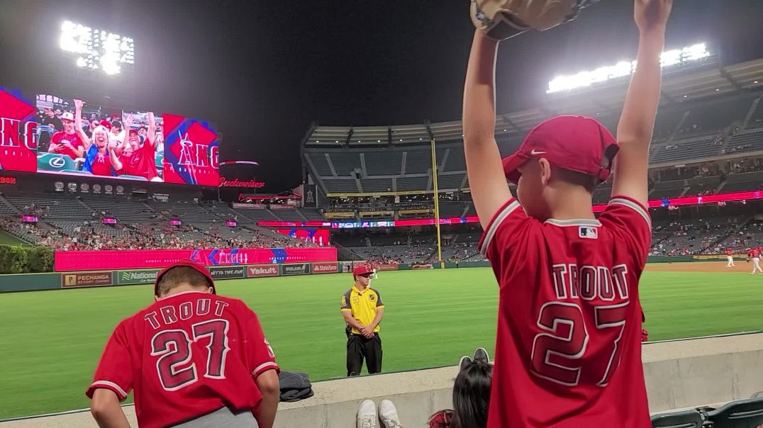 J Funk tries to get baseball from players at Angel's game