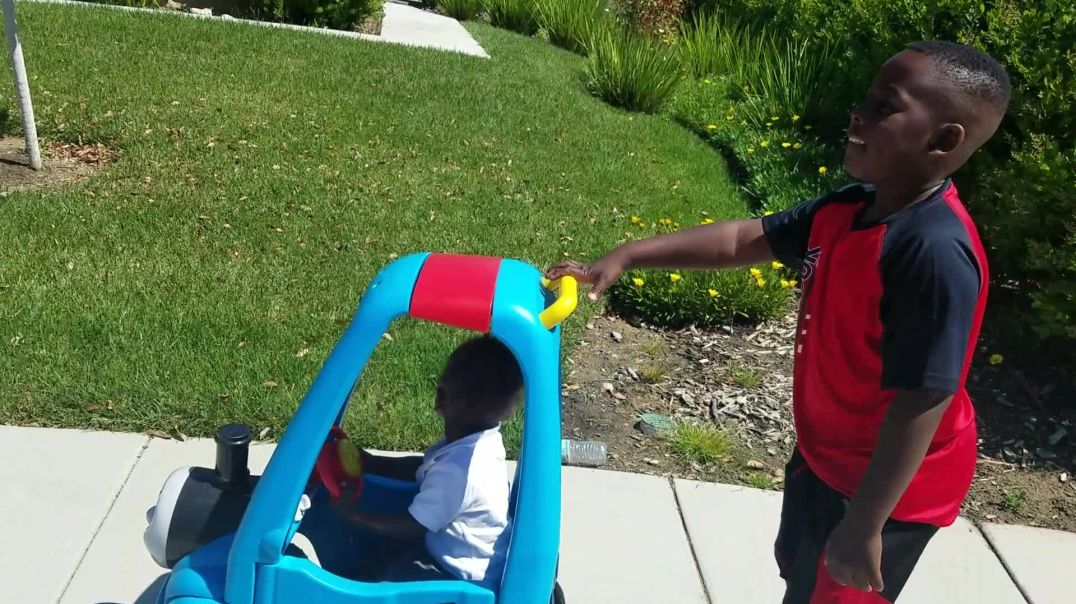 ⁣J Funk pushes miracle baby Josiah in Thomas the train stroller cart