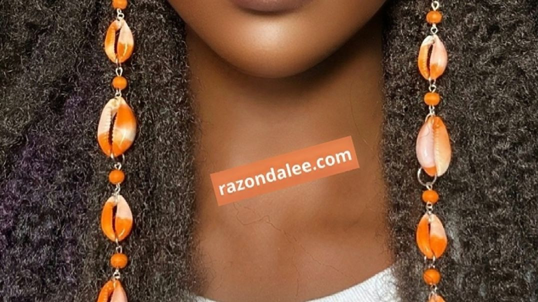 ⁣Elongated Cowrie Shell Earrings by Razonda Lee